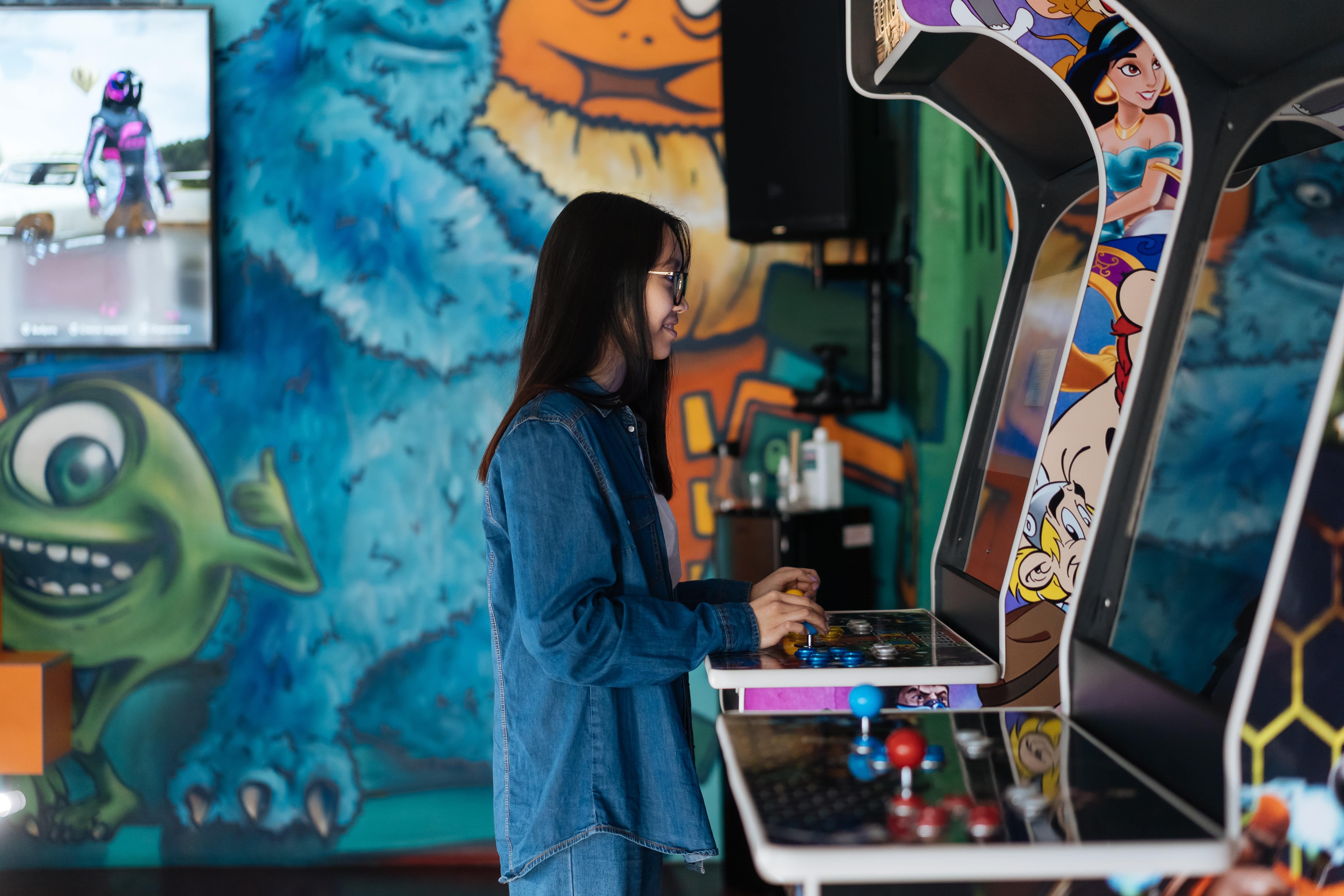 Girl using an arcade machine